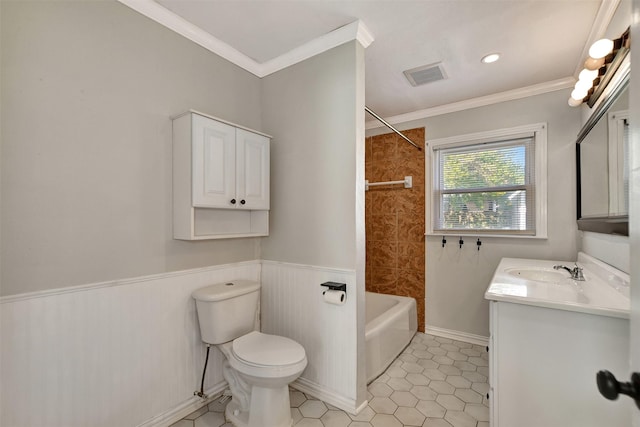 full bathroom featuring vanity, toilet, tiled shower / bath combo, and crown molding