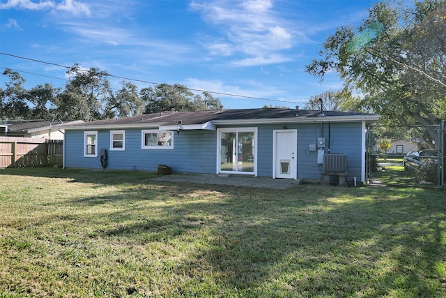 rear view of property with a yard