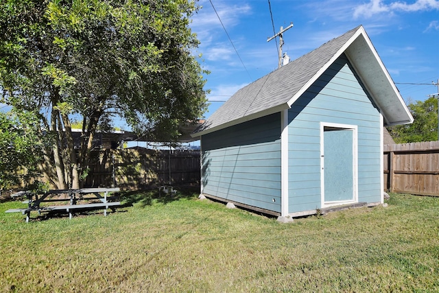 view of outbuilding with a yard