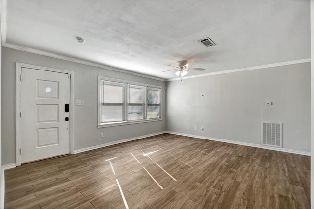 interior space with wood-type flooring, ceiling fan, and crown molding