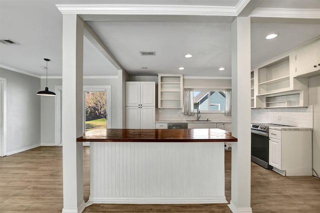 kitchen featuring butcher block countertops, a healthy amount of sunlight, sink, and stainless steel appliances