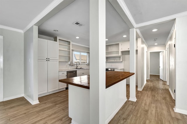 kitchen featuring wooden counters, decorative backsplash, ornamental molding, white cabinets, and light hardwood / wood-style floors