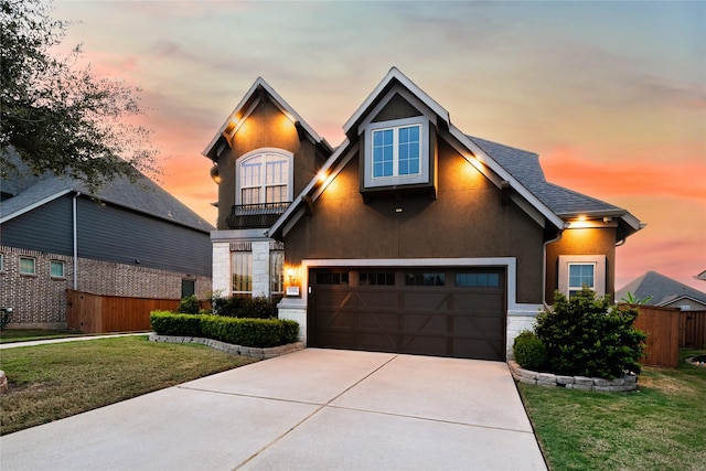 view of front of property featuring a garage and a lawn