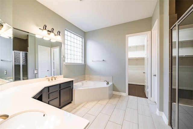 bathroom with vanity and independent shower and bath