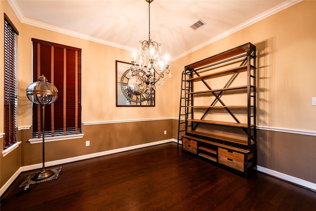 spare room with hardwood / wood-style flooring, an inviting chandelier, and ornamental molding