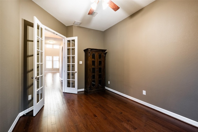 spare room with dark hardwood / wood-style flooring, ceiling fan, and french doors