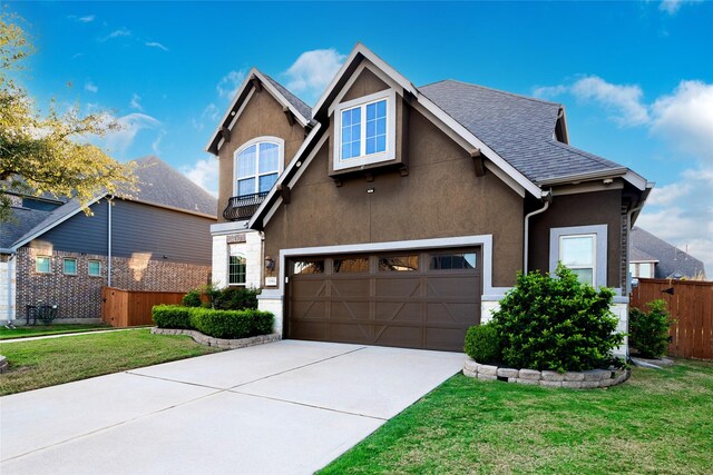 view of front of property featuring a garage and a front lawn