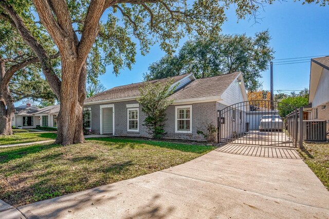 single story home featuring a front yard and central air condition unit