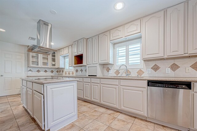 kitchen with island exhaust hood, white cabinets, tasteful backsplash, sink, and dishwasher