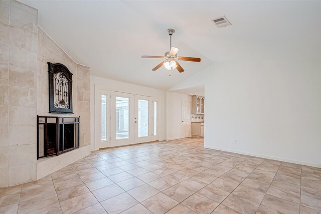 unfurnished living room featuring french doors, vaulted ceiling, ceiling fan, and light tile patterned flooring