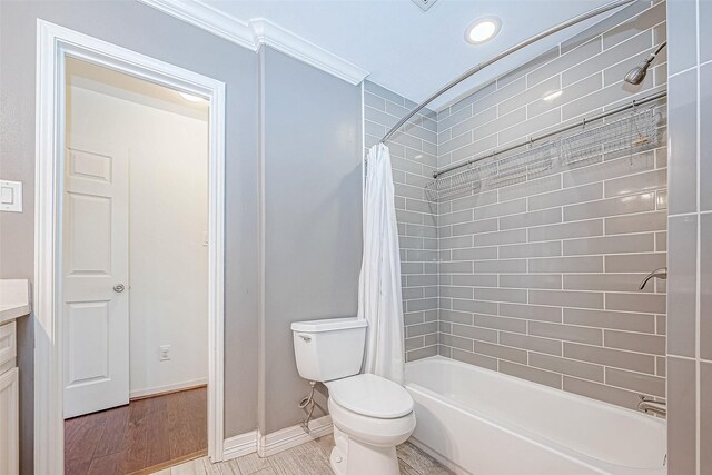 full bathroom with vanity, shower / tub combo with curtain, crown molding, wood-type flooring, and toilet