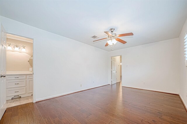 empty room featuring ceiling fan and dark hardwood / wood-style floors