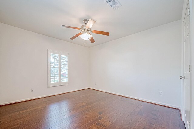 unfurnished room with ceiling fan and dark wood-type flooring