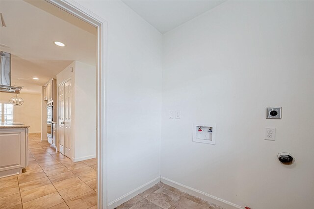 laundry area featuring hookup for an electric dryer, light tile patterned flooring, and hookup for a washing machine