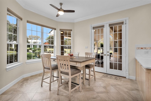 dining space with ceiling fan, crown molding, and french doors