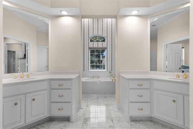 bathroom with a washtub and vanity