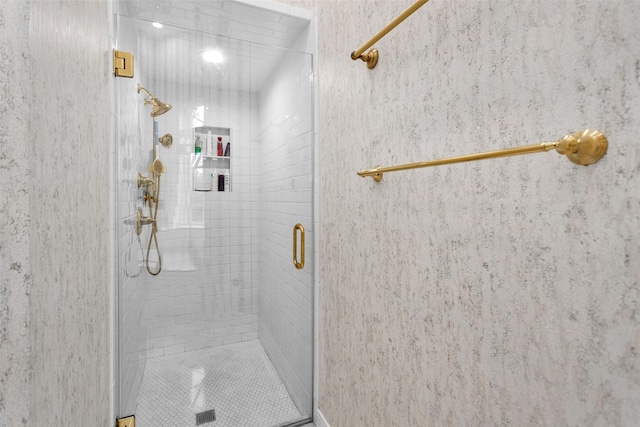 bathroom with a shower with door