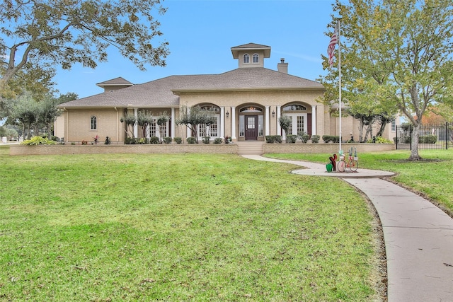 view of front of property with a front yard and covered porch