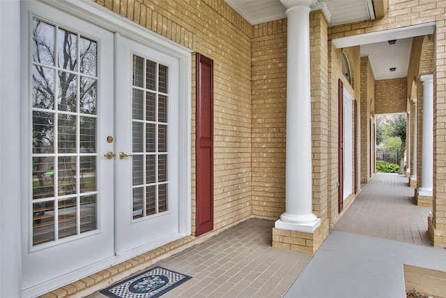 entrance to property featuring a porch and french doors