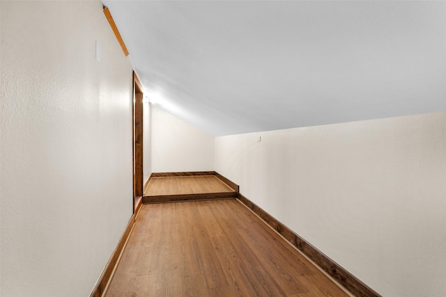 bonus room featuring hardwood / wood-style floors and vaulted ceiling