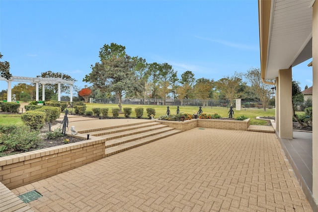 view of community with a pergola and a patio