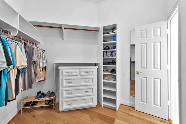 spacious closet with light hardwood / wood-style floors