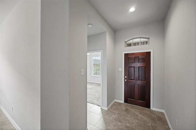 entryway featuring light colored carpet