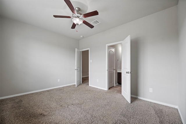 unfurnished bedroom with ceiling fan and light colored carpet