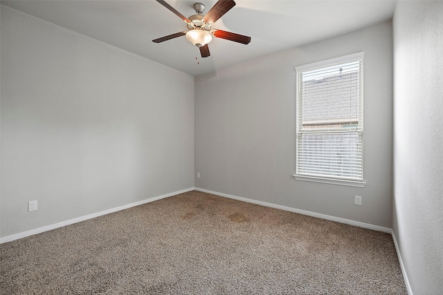 unfurnished room featuring ceiling fan and carpet floors