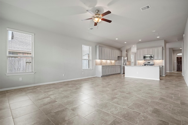 unfurnished living room featuring ceiling fan