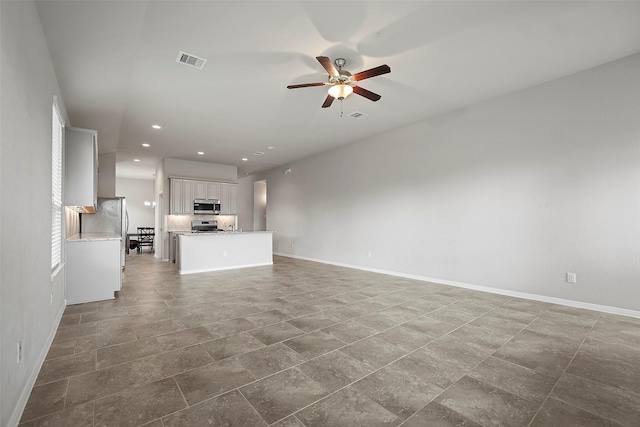 unfurnished living room featuring ceiling fan