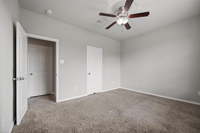 unfurnished bedroom with ceiling fan and light carpet