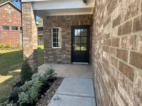 view of exterior entry featuring a patio