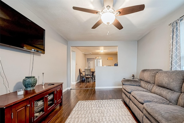 living room with ceiling fan and dark hardwood / wood-style flooring