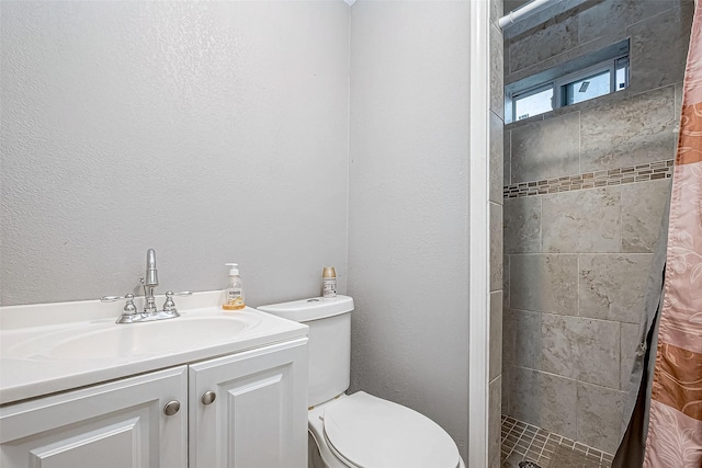 bathroom with vanity, toilet, and walk in shower