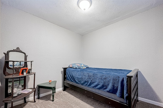 carpeted bedroom with a textured ceiling