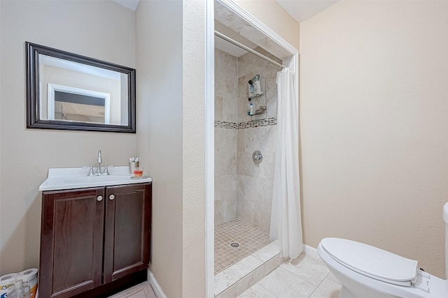 bathroom with tile patterned flooring, a shower with curtain, vanity, and toilet