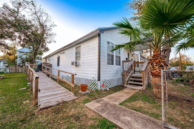 view of property exterior with a wooden deck and a yard