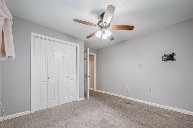 unfurnished bedroom featuring carpet, a closet, and ceiling fan