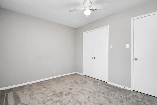 unfurnished bedroom featuring carpet and ceiling fan