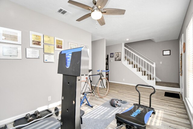 workout area with hardwood / wood-style flooring and ceiling fan