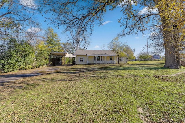 ranch-style home featuring covered porch and a front lawn