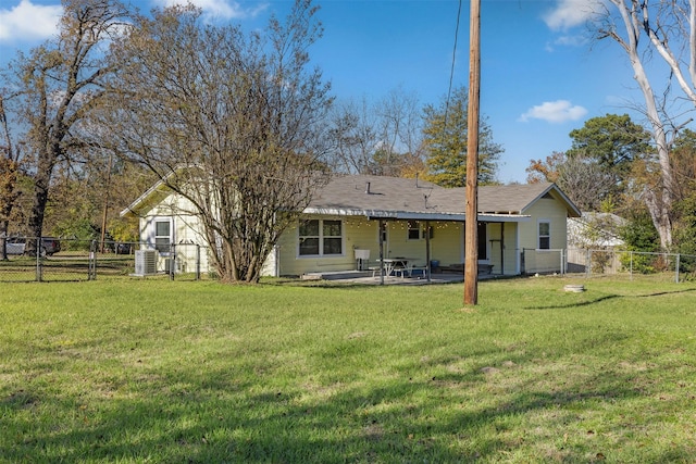 rear view of house with a lawn and a patio