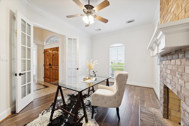 dining area featuring a fireplace, dark hardwood / wood-style flooring, and crown molding