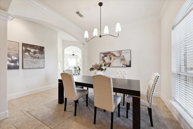 tiled dining area with a healthy amount of sunlight, ceiling fan with notable chandelier, and ornamental molding