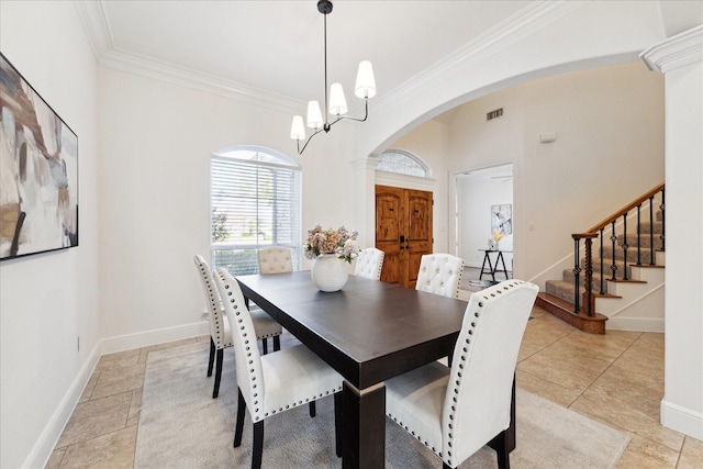 tiled dining space with crown molding and a notable chandelier