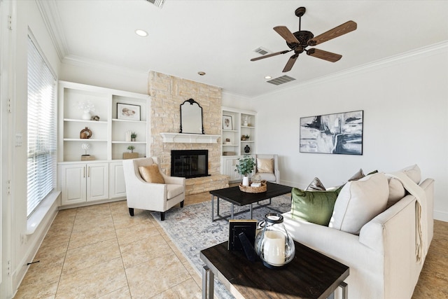 tiled living room featuring a fireplace, built in shelves, ceiling fan, and crown molding