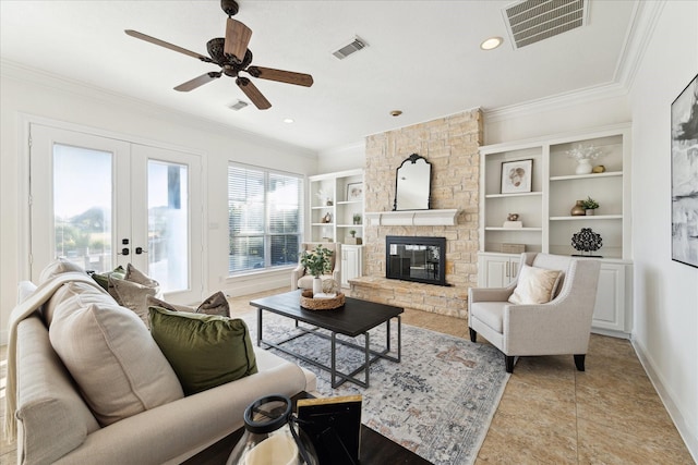 living room featuring french doors, ceiling fan, ornamental molding, a fireplace, and light tile patterned floors