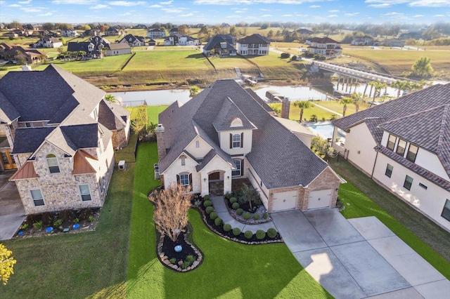 birds eye view of property with a water view