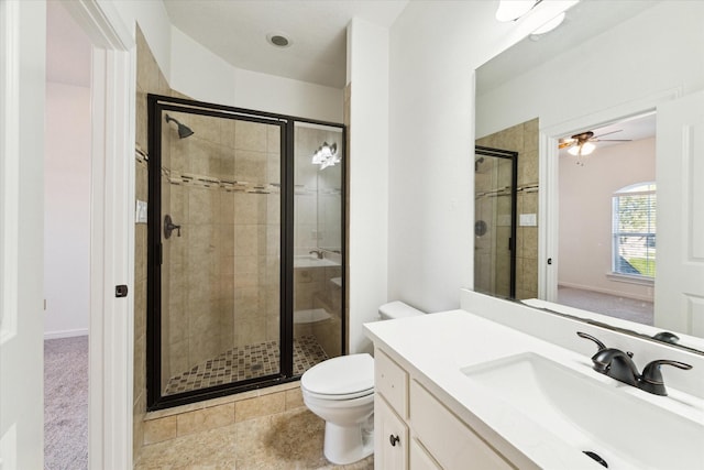 bathroom featuring walk in shower, vanity, ceiling fan, tile patterned flooring, and toilet